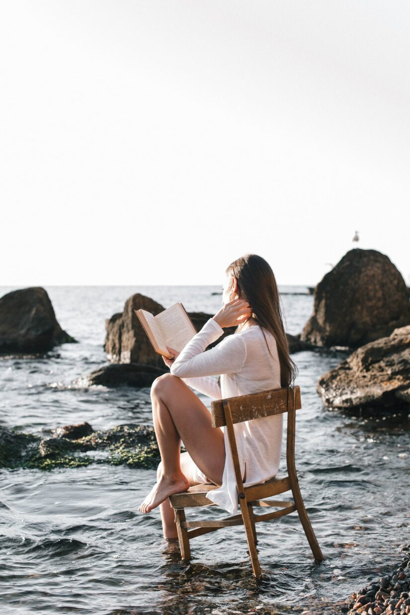 Woman sitting with one foot in the water