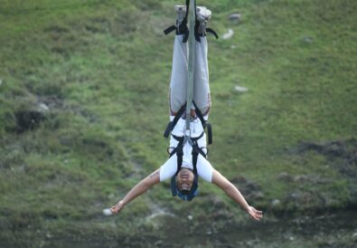 A man hanging upside down from a bungee cord